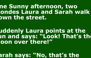 Two blondes walk down the street.