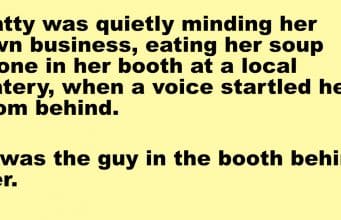 A woman was eating her soup alone in her booth