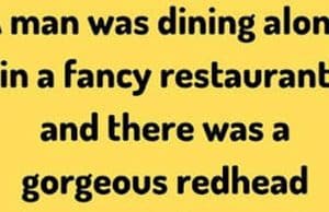 A man and a gorgeous redhead in a fancy restaurant.